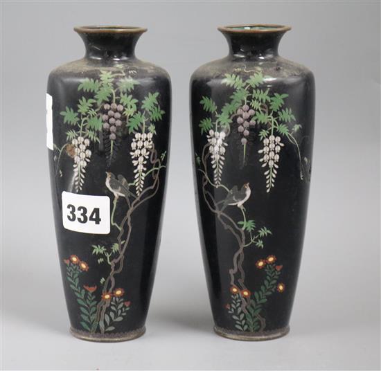 A pair of Japanese cloisonne enamel vases, decorated with flowering prunus, irises and other flowers on a black height 7in.